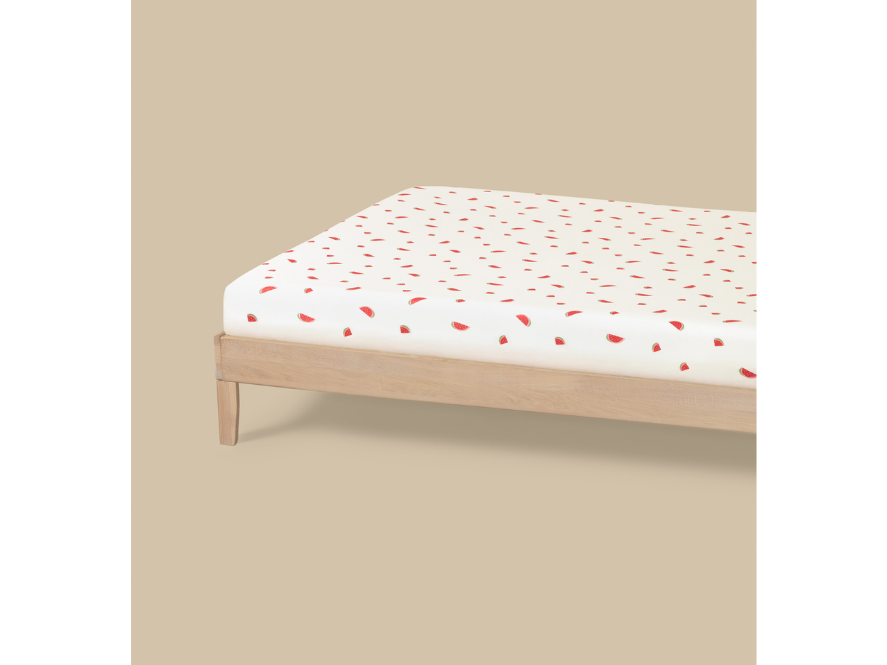 Livarno Jersey Fitted Sheet with watermelon pattern on a wooden bed frame.