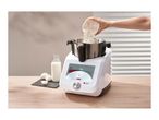 Monsieur Cuisine Smart food processor with flour being added, milk and eggs nearby.