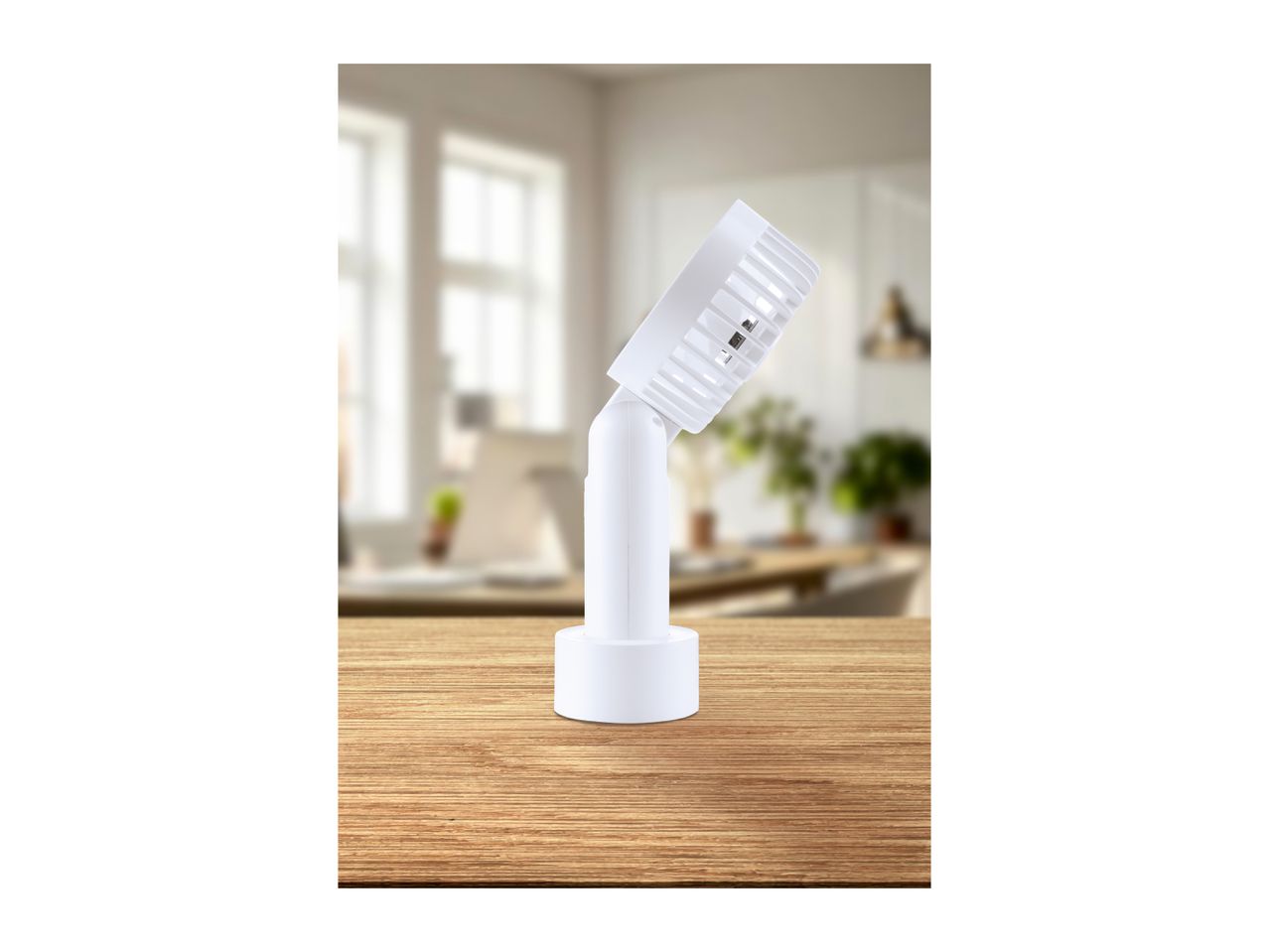 White adjustable LED spotlight on a wooden table with a blurred office background.