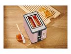 Pink toaster with toast, jam, and a knife on a wooden table.
