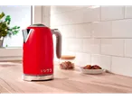 Red Silvercrest® kettle on a wooden kitchen counter, with cookies and sugar.