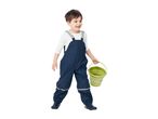 Smiling child in blue waterproof overalls holding a green bucket.