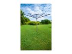 Rotary clothesline in a green garden under a blue sky with white clouds.