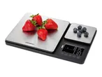 Digital kitchen scale with two weighing platforms, displaying strawberries and blueberries.
