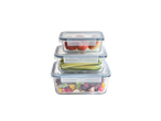 Stacked SILVERCREST® Glass Food Storage Containers with fruit, cucumber, and salad.