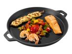 Grilled chicken skewer, salmon fillet, shrimp, and mixed bell peppers on a black cast iron pan.