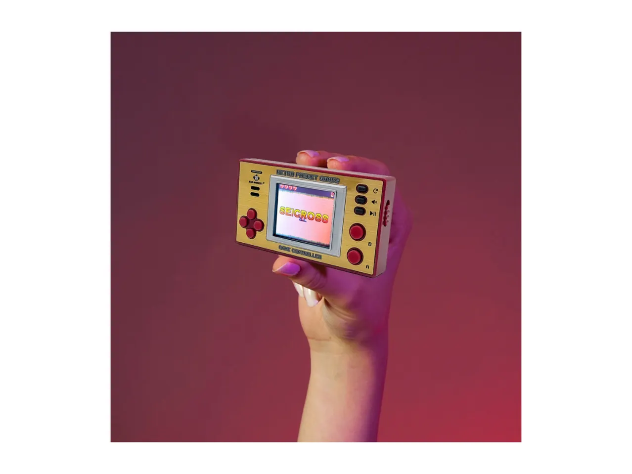 Hand holding a retro pocket game console with 'SEICROSS' on the screen.