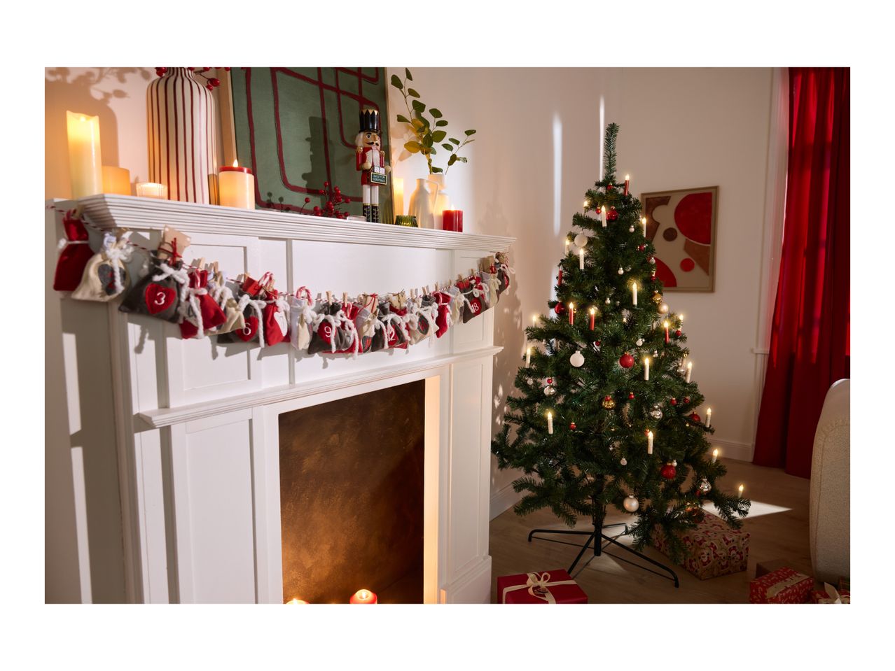 Christmas tree with candles and ornaments next to a fireplace with an advent calendar