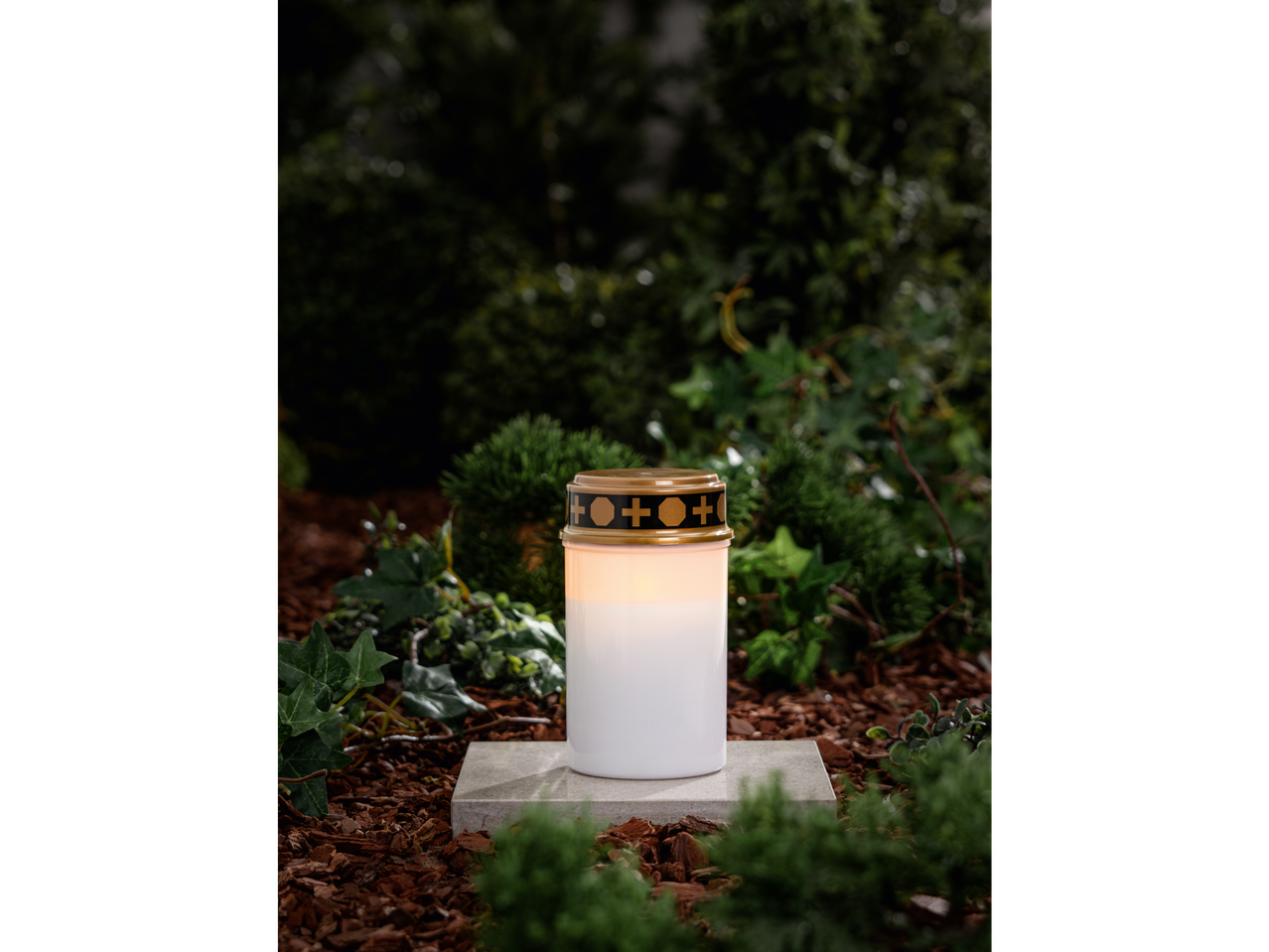 LIVARNO home LED Grave Light on a stone slab amidst greenery and wood chips