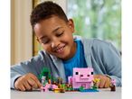 A boy playing with a LEGO Minecraft pig farm set.