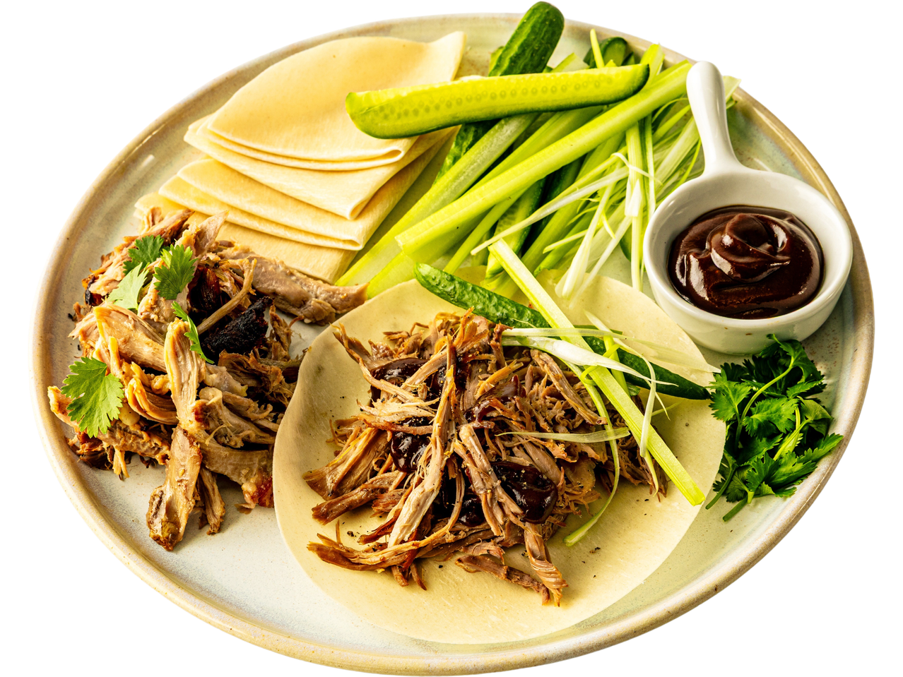 Peking duck with pancakes, cucumber, scallions, and hoisin sauce.