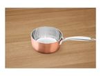 Copper-colored saucepan with measurement markings on a wooden surface