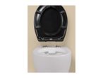 White toilet with an open black toilet seat against a beige background.