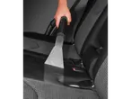 Cleaning car seats with a vacuum cleaner.