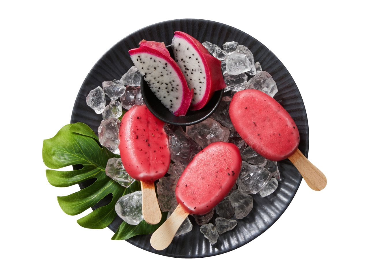 Dragon fruit ice lollies on a black plate with ice and dragon fruit slices.