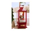 Red Christmas lantern with Santa figurine, artificial snow, and a 'CHRISTMAS' plaque.