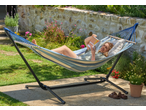 Livarno Hammock with Frame, a woman relaxing and reading a book in a garden.
