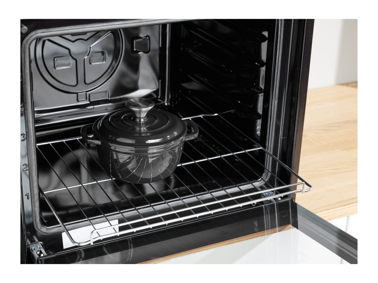 Black oven interior with a black pot on a metal rack, showing rack levels 1, 2, and 3.