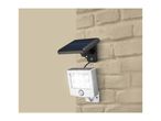 Solar-powered LED wall light with motion sensor mounted on a brick wall.