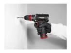 A person drilling into a white wall with a Parkside cordless drill.