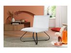 White bouclé lounge chair with black metal legs in a living room with terracotta walls.