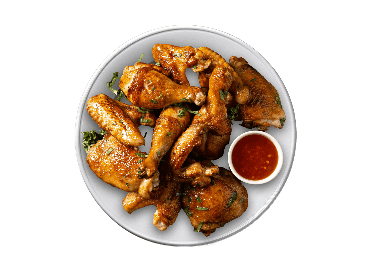 Eine Platte mit knusprigen Hähnchenteilen und einer Schale süßer Chilisauce.