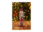 Nutcracker figurine with a candy cane and gingerbread man, on a wooden table with Christmas lights.