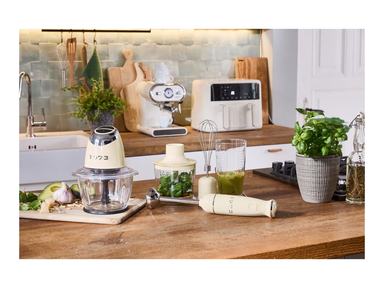 Cream-colored kitchen appliances, including a food processor, blender, and espresso machine.