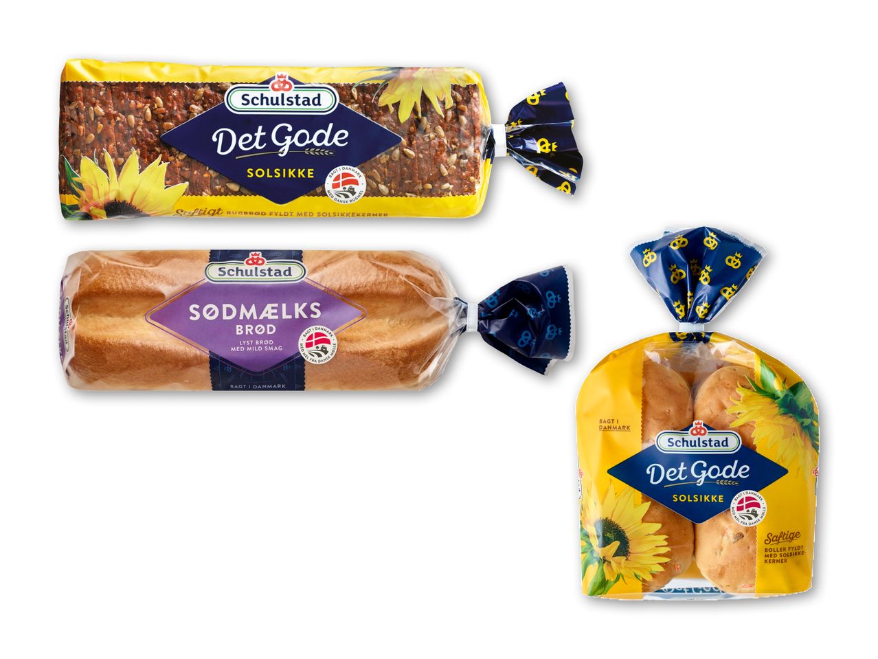 Tre pakker brødprodukter: et rugbrød med solsikkekerner, et sødmælksbrød og en pose solsikkeboller.