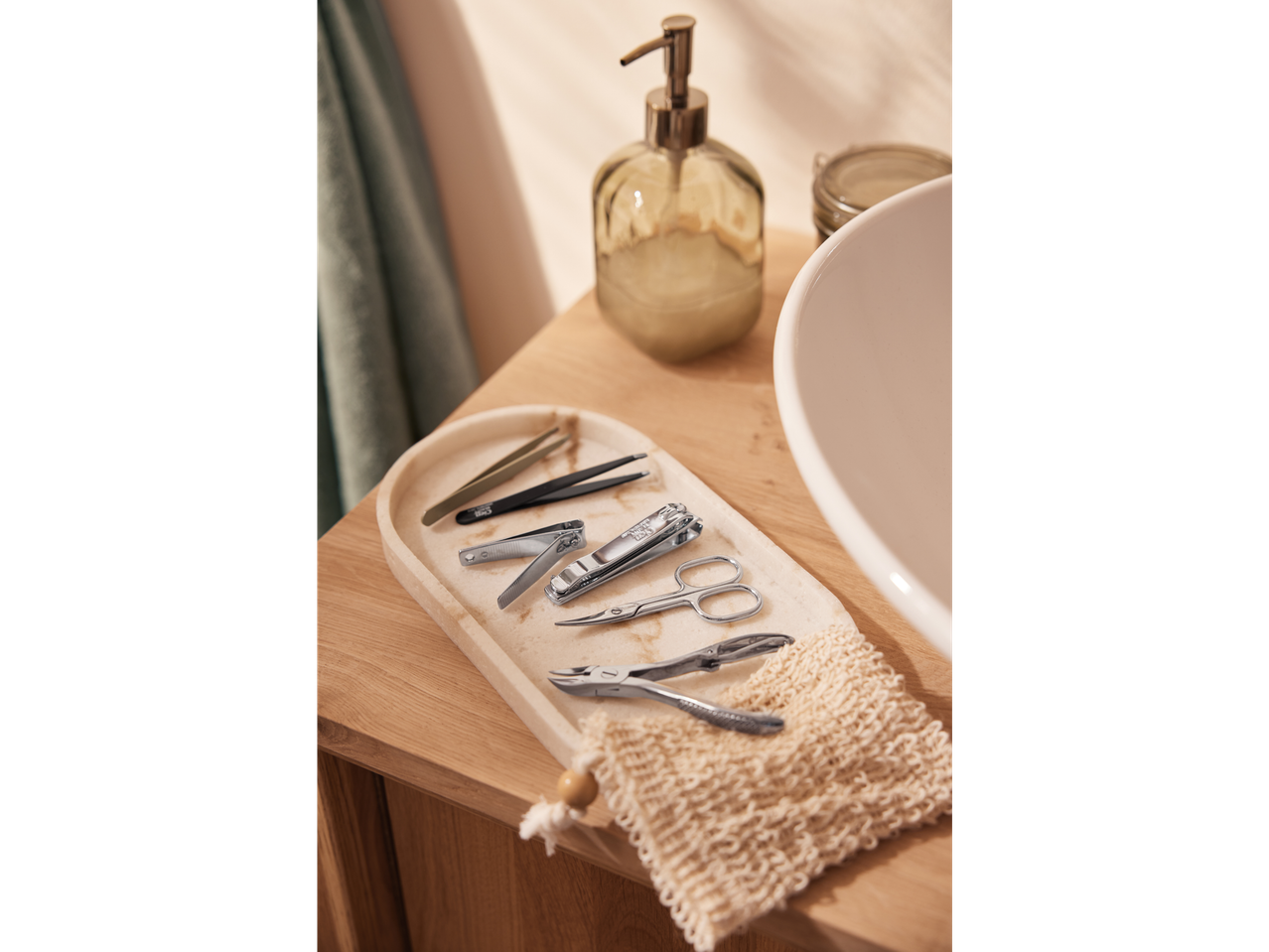 Manicure and pedicure tools on a marble tray.