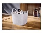A patterned plastic storage basket filled with cleaning supplies on a wooden floor.