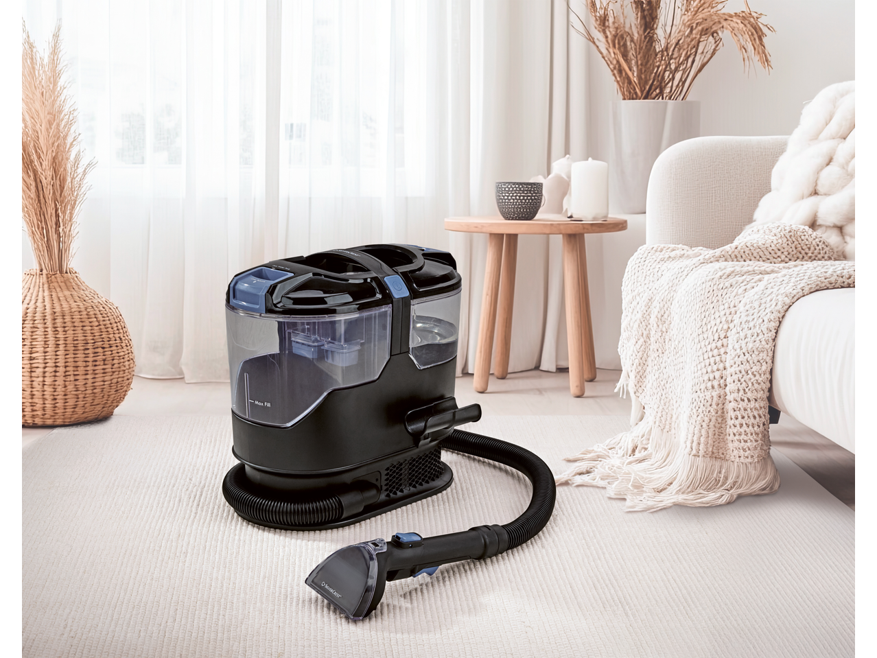 Carpet cleaner on a light rug in a living room setting.