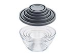 A set of nesting glass mixing bowls with matching silicone lids.