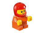 A small toy figure with an orange body, yellow hands, and a red helmet.