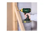 A person using a cordless impact driver to screw into a wooden frame.