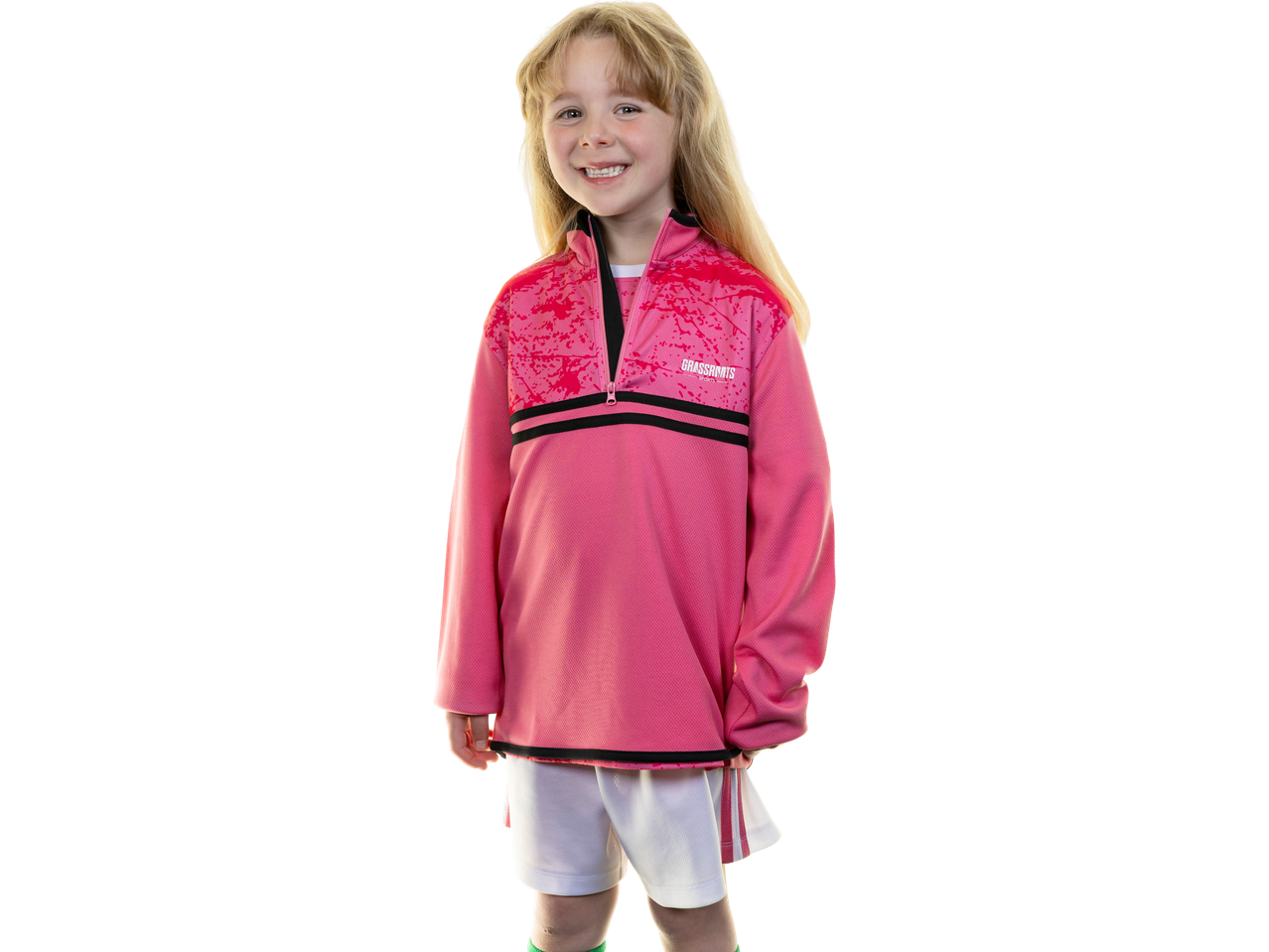 Smiling girl in a pink Kids' Training Jersey with black stripes and white shorts.