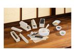 Sushi making kit with various molds, rice, sushi rolls, and dipping sauces on a wooden table.
