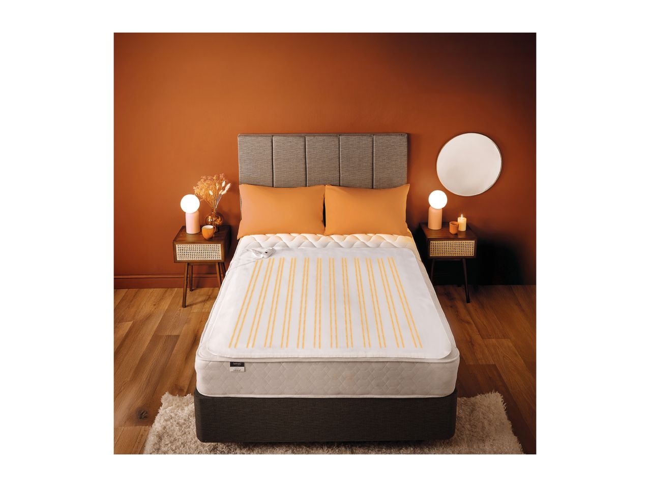 Heated underblanket on a double bed in a modern bedroom with warm lighting.