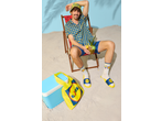Man in Lidl shirt, bucket hat, shorts, socks, and slides, holding a pineapple drink on a beach chair.
