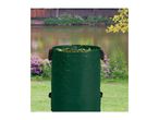 Green garden waste bag filled with leaves, set against a scenic pond and garden backdrop.