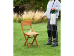 Man cleaning a wooden chair with a Parkside® garden sprayer.