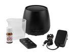 Black aroma diffuser with remote control, measuring cup, essential oil, and power adapter.