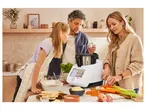 A family cooks dinner using a multi-functional food processor and fresh ingredients.