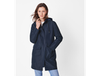 A woman in a navy blue rain jacket and light wash jeans.