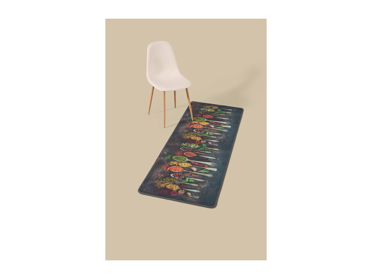 Kitchen runner with a spice spoon pattern, next to a white chair on a beige background.