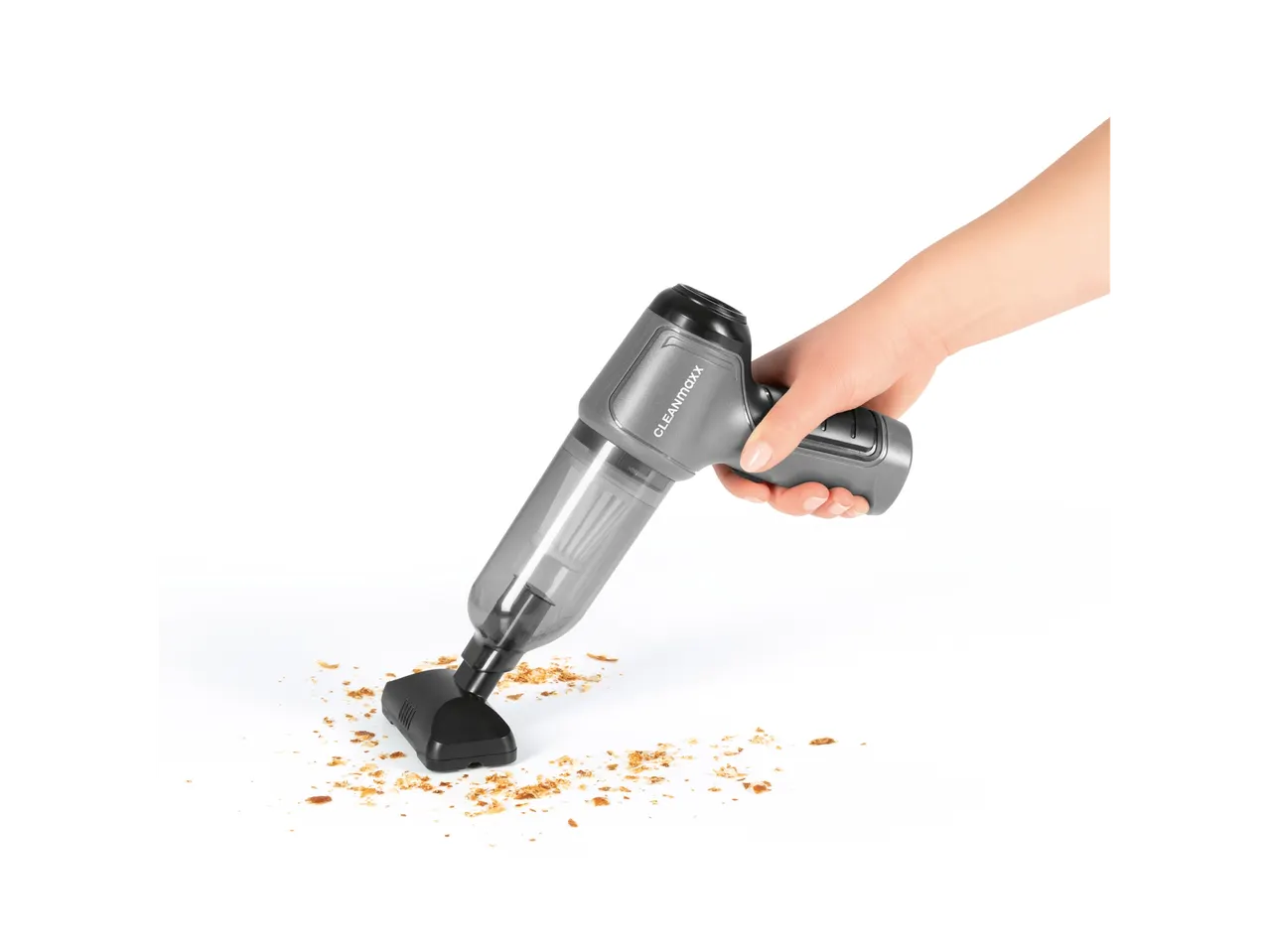 L'aspirapolvere senza fili Cleanmaxx pulisce le briciole da una superficie bianca.