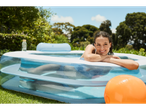 Inflatable pool, ball, and relaxed woman.