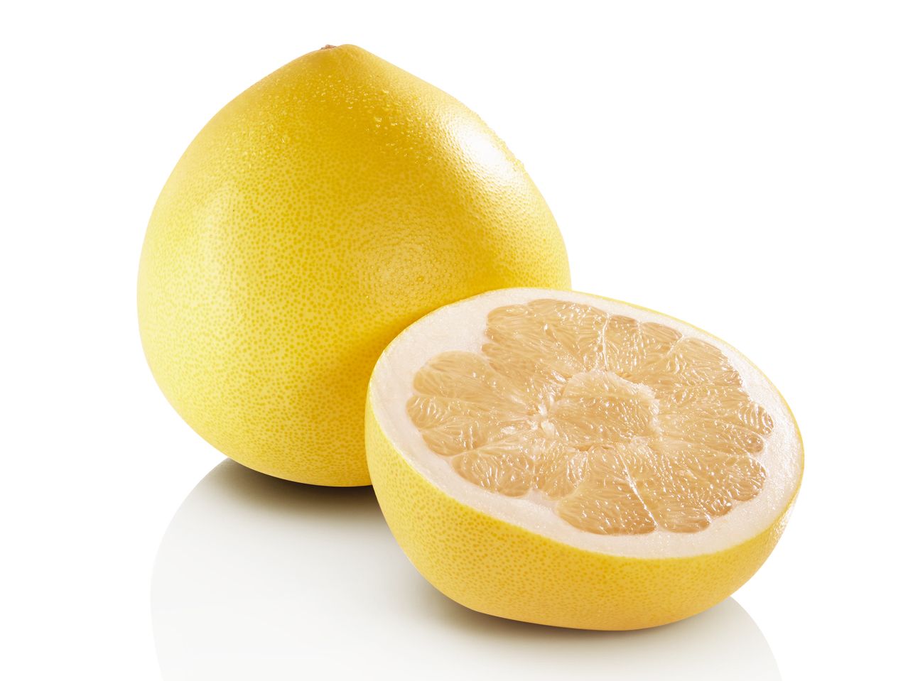 Un pomelo întreg și unul tăiat în jumătate, cu pulpă galbenă, pe un fundal alb.