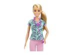 Barbie doctor doll wearing a teal scrub top with medical icons and pink pants, holding a purple stethoscope.