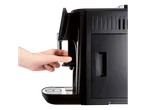 Hand operating a black espresso machine.